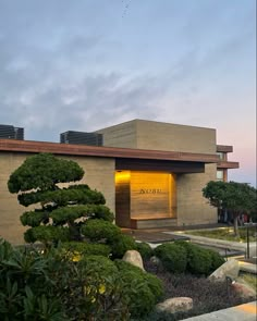 a building with trees and bushes in front of it