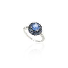 a blue and white diamond ring on a white background