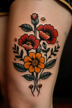 a woman's thigh with flowers and leaves on it