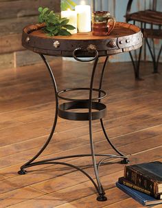 a small table with candles on it and some books next to it in a room