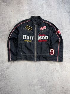 Get ready to race in style with this vintage Harrison Racing Team jacket. Made from durable polyester outer shell material, this mid-length motorcycle jacket is perfect for all seasons, whether you're riding in the summer, fall or spring. The black jacket features a solid pattern with embroidered accents and a Harrison Racing logo, giving it a retro 90s style. With zipped pockets and a lightweight design, this jacket is both functional and fashionable. It has a regular fit and comes in XL size, making it perfect for men who want to show off their love for cars, bikes and all things USA. Whether you're a daredevil on the track or just want to look the part, this Harrison Gibson Vintage Racing Team Jacket is the perfect addition to your wardrobe.  Size XL (see measurements) The length of the Cafe Racer Biker Jacket With Long Sleeves For Streetwear, Retro Long Sleeve Biker Jacket For Outdoor, Cafe Racer Biker Jacket For Streetwear, Sporty Long Sleeve Biker Jacket For Motorcycling, Black Moto Outerwear For Streetwear, Casual Biker Jacket With Zipper Closure, Black Motorcycle Outerwear With Durable Zipper, Casual Motorcycle Outerwear With Zipper Closure, Retro Black Outerwear With Graphic Print