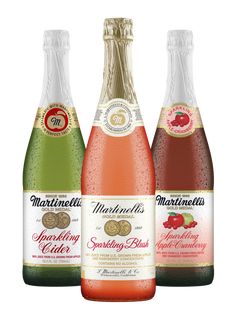 three bottles of sparkling cider on a white background