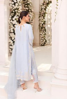 An enchanting three piece design on ice blue raw silk with intricate embroidery details alongside clusters of hand sewn pearls. Paired with a frilly dupatta and embroidered trousers for elegance unmatched. Order Duration: 4 to 6 weeks Embroidered Trousers, Mom Dresses, Traditional Suit, Pakistani Style, Sleeves Designs For Dresses, Hijabi Outfits Casual, Hijabi Outfits, Abstract Line Art, Stylish Dress Designs