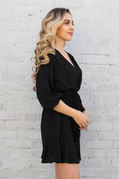 Whether you're going to work, after hour drinks or a dinner party, this amazing v neck dress is prefect for any occasion. The removable tie belt can be styled to your liking, while the quarter sleeves can be pulled down the arm for a longer look, or hiked up the bicep for a unique bubble-like sleeve. Pair with heel and a clutch. V neckline Pleated front Elastic-lined waist Removable tie belt 3/4 sleeves 97% Polyester, 3% Spandex SKU #: D-4482 V-neck Mini Dress With Tie Waist For Work, Black V-neck Mini Dress With Tie Waist, Belted Mini Dress With Surplice Neckline For Date Night, Surplice Neckline Belted Mini Dress For Date Night, Date Night Surplice Neckline Mini Dress, Elegant Dresses With Tie Sleeves For Day Out, Surplice Neckline Mini Dress With Tie Waist For Brunch, Chic Belted Midi Dress With 3/4 Sleeves, Brunch Mini Dress With Tie Waist And Surplice Neckline