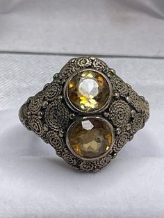 "This is a beautiful vintage Theodor Fahrner sterling silver and golden topaz ring.  The marks on the ring are harder to decipher as the ring has been sized down with sizing balls soldered to the band but its \"TF\" in a circle mark is still visible as well as \"ER\" of Fahrner.  The ring is in very good vintage condition, there is some surface wear, a couple scratches, and small flea bites to the golden topaz stones, wear to the filigree on the sides of the ring, and there also appears to be an area on the back of the band where we think it was rubbed or tested for silver purity.  The ring is a size 7 and the ring weighs approximately 7.58 grams. - For international customers, please note that customs or duty fees are the buyer's responsibility and are not included in the price." Antique Adjustable Rings With Intricate Design, Antique Silver Engraved Ring, Antique Finish Rings For Anniversary, Antique Finish Anniversary Jewelry Ring, Vintage Jewelry With Intricate Design Toe Ring, Heirloom Style Antique Finish Rings For Anniversary, Heirloom Rings With Antique Finish For Anniversary, Vintage Toe Ring With Intricate Design, Antique Silver Engraved Open Ring