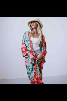 The Tie Front Boho Chic Teal Floral Kimono is easily spring and summer's trendiest accessory. This boho chic kimono is a fresh solution to your basic tee and jeans rut. The versatile and vibrant floral print kimono instantly brightens any day. The perfect layering piece for a tank and shorts combo, a little sundress, or as a beach cover-up. One Size. Layering for sundress, tank and shorts/jeans, beach cover-up 100% Rayon Fabric that is soft and breathable Measures: 42" Length Sleeves: 14" Long x Bohemian Kimono Relaxed Fit For Festival, Bohemian Kimono For Festivals In Relaxed Fit, Bohemian Style Relaxed Fit Kimono For Festival, Casual Patterned Kimono For Beach Cover-up, Long Bohemian Summer Kimono, One Size Green Bohemian Kimono, Bohemian Multicolor Kimono For Vacation, Multicolor Bohemian Kimono For Vacation, Summer Long Bohemian Kimono