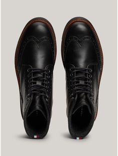 Tommy Hilfiger men's boot. Traditional brogue detailing lends a stylish touch to these lace-up boots, while warm linings and water-repellent leather make them ideal for tran-seasonal wear.  Material: 100% Leather (fwa). Classic Brogue Lace-up Boots For Derby, Casual Brogue Ankle Lace-up Boots, Classic High-top Lace-up Boots, Casual Wingtip Lace-up Boots For Work, Fall Wingtip Lace-up Boots With Leather Lining, Winter Lace-up Boots With Brogue Detailing, Formal Winter Lace-up Boots With Rubber Sole, Business Chukka Boots With Brogue Detailing, Casual Wingtip Lace-up Boots With Rubber Sole