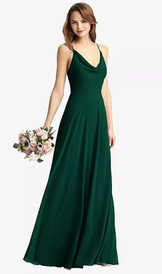 a woman in a long green dress holding a bouquet