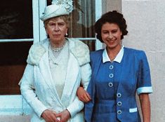 two women standing next to each other in front of a window wearing blue and white outfits