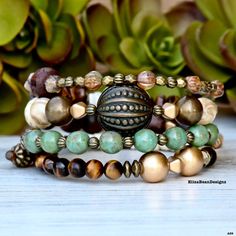 Express your unique style with this one of kind stack!   Beautiful soft colors and an eye catching Vintage Focal Bead from the 70s, make this the piece you will want to wear all of the time! **ONE OF A KIND For added health benefits, add your favorite essential oil to the Lava Stone. Made of memory wire that easily wraps around your wrist creating an incredible layered look in one bracelet. TO MAINTAIN THE INTEGRITY OF YOUR  HIGH QUALITY GEMSTONE BRACELET  PLEASE FOLLOW THESE CARE INSTRUCTIONS: Bohemian Stacked Round Bead Bracelets, Stackable Wrap Bracelet For Layering, Handmade Bohemian Beaded Bracelets For Layering, Bohemian Stackable Wrap Bracelet As Gift, Brown Beaded Bracelet With Unique Variations For Gift, Brown Beaded Bracelet With Unique Variations As Gift, Adjustable Natural Stones Bracelets For Layering, Bohemian Stackable Beaded Bracelets For Meditation, Bohemian Style Adjustable Bracelet For Layering