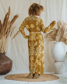 Presenting the Golden Lotus - Short Kimono, a unique piece from our slow fashion collection that's designed to radiate your confidence and individuality. This distinct piece is reversible, displaying meticulous craftsmanship and made-to-order for an opulent appearance that's sure to captivate attention. Size: Our model has the following measurements: Height: 172 cm | 5 ft 7 inches Chest: 88-94 cm | 35-37 inches She is wearing size M kimono with 85 cm | 33 inch length. Fitted Kimono For Spring Loungewear, Fitted Maxi Length Kimono, Fitted Bohemian Wrap Kimono, Fitted Long Sleeve Silk Robe, Fitted Floral Kimono For Festival, Fitted Silk Bohemian Outerwear, Silk Fitted Robe For Spring, Spring Long Sleeve Fitted Kimono, Spring Fitted Long Sleeve Kimono