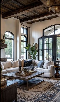 a living room filled with furniture and lots of windows