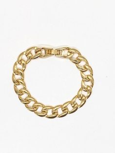 "Add a dose of tough-luxe glamour to after-dark looks with this golden curb-chain bracelet. ✤ Available in 14k Gold plated brass ✤ Chain size 10 mm wide ✤ Come in size 5.5, 6, 6.5, 7, 7.5 and 8 mm Please choose from drop down box ✤Watch Clasp-Curb Chain Push-release closure S I Z I N G Take a yarn or string wrap it around your wrist and cut it when the ends meet. Take the piece of yarn and measure it on a ruler. Let us know your size in a note and we will take care of the size for you. All purch Watch Clasp, Bracelet Thick, Cuban Link Bracelet, Chunky Bracelet, Chunky Chain Necklaces, Big Hoop Earrings, Link Chain Bracelet, Family Necklace, Gold Cross Necklace