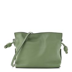 This is an authentic LOEWE Calfskin Mini Flamenco Knot Bag in Avocado.This chic and lovely tote is crafted of luxuriously soft calfskin leather in green. This shoulder bag features green leather cinch cords, an optional shoulder strap, and gold hardware. The top opens to a brown suede fabric interior. Designer Green Leather Bags, Luxury Green Bag With Rolled Handles, Luxury Green Bags With Rolled Handles, Luxury Green Bag With Smooth Grain, Designer Green Leather Shoulder Bag, Luxury Olive Leather Shoulder Bag, Luxury Green Soft Leather Bag, Green Shoulder Bag With Rolled Handles For Travel, Luxury Green Smooth Grain Shoulder Bag