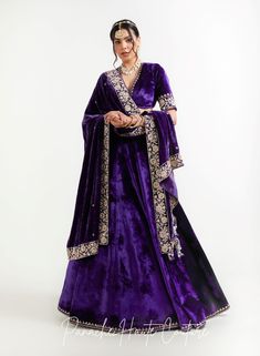 The violet color of lehenga set adds a regal touch, while the shawl can provide an additional layer of warmth and elegance. It is adorned with intricate embroidery, sequins, or other embellishments to make it stand out. When wearing a lehenga set, it's important to choose accessories that complement the outfit without overpowering it. A simple pair of earrings, a bracelet, and a clutch in a complementary color can be all that is needed to complete the look. Overall, a Violet Color Lehenga Set with a shawl from the Sensual Shadows Collection can be a stunning choice for anyone looking to make a statement with their fashion choices. The vibrant colors and intricate details are sure to turn heads and make the wearer feel like royalty. Brand: Panache Haute Couture Collection Name: The Sensual Designer Indian Wear, Curated Outfit, Violet Color, Types Of Embroidery, Computerized Embroidery, Intricate Embroidery, Indian Design, Couture Collection, Indian Wear