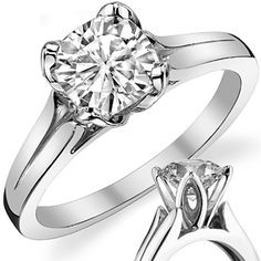 an engagement ring with a diamond in the center and a wedding band on each side