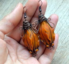 These burnt orange dangle (drop) floral earrings are made of polymer clay and copper. Statement and unique piece of jewelry in warm autumn colors can be a part of your fashion not only this fall, but all over the year. Tender and bright pods will emphasize the individuality of their owner. The earrings can be a beautiful gift for your beloved woman to make her happy. Earring length is about 1.57 inches. Can be made in different colors and sizes. Perfect match to the pendant: https://www.etsy.com Brown Polymer Clay Drop Earrings, Artisan Orange Copper Earrings, Orange Wire Wrapped Earrings For Gift, Nickel-free Copper Orange Earrings, Nickel Free Copper Orange Earrings, Nickel-free Orange Copper Earrings, Orange Dangle Polymer Clay Jewelry, Orange Dangle Jewelry In Polymer Clay, Orange Polymer Clay Dangle Jewelry