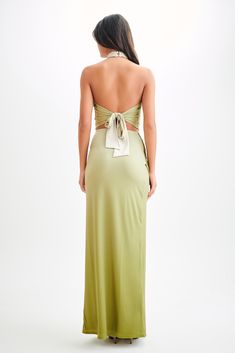 the back of a woman wearing a green dress with a bow on it's belt