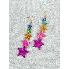 Indulge in stunning style with the Super Star Earrings in Rainbow. Crafted with precision from sparkling acrylic, a series of five stars are masterfully connected to form dazzling constellations, ideal for any occasion, whether it be a celebration, a gift, or a fancy dress event. Hang them from the hypoallergenic gold-tone hooks and just wait until you start dancing: these bold earrings will sway and twinkle along with your every move. Multicolor Star Charm Jewelry For Party, Trendy Star Embellished Jewelry For Parties, Trendy Star Embellished Party Jewelry, Trendy Star-embellished Party Jewelry, Star Charm Earrings For Party, Multicolor Star Earrings For Parties, Multicolor Star-shaped Party Earrings, Dangle Earrings With Star Charm For Party, Sparkling Star-shaped Jewelry For Parties