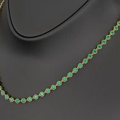 Adorn her with timeless elegance with our 9.36 Carat Natural Emerald Choker Necklace in 14K Gold. This bezel-set, round-cut art deco design showcases the vibrant May birthstone, making it a perfect customized birthday gift for her. Exuding luxury and sophistication, this stunning necklace is a refined statement piece crafted to celebrate life’s special moments. 𝐅𝐞𝐚𝐭𝐮𝐫𝐞𝐬:• 𝐌𝐚𝐝𝐞 𝐭𝐨 𝐎𝐫𝐝𝐞𝐫• 𝐌𝐞𝐭𝐚𝐥: 𝟏𝟎𝐊 𝐆𝐨𝐥𝐝 | 𝟏𝟒𝐊 𝐆𝐨𝐥𝐝 | 𝟏𝟖𝐊 𝐆𝐨𝐥𝐝 • 𝐁𝐚𝐧𝐝 𝐂𝐨𝐥𝐨𝐫𝐬: Ro Elegant Round Gemstone Tennis Necklace, Elegant Gemstone Tennis Necklace, Formal Round Diamond Necklace With Gemstones, Formal Gemstone Tennis Necklace, Luxury Gemstone Tennis Necklace, Luxury Hand Set Round Emerald Necklace, Luxury Hand-set Round Emerald Necklace, Elegant Gold Emerald Necklace, Classic Gemstone Tennis Necklace - Gift