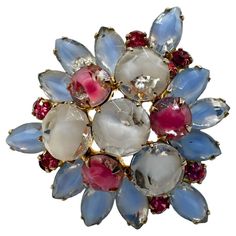 Dazzle and delight with this exquisite Vintage White Blue & Pink Glass and Rhinestone Brooch. A timeless piece that captures the essence of yesteryears, this brooch is a harmonious blend of delicate hues and intricate craftsmanship. The brooch features a captivating arrangement of vintage white, serene blue, and soft pink glass, creating a palette that whispers of bygone elegance. The meticulous detailing is enhanced by the subtle sparkle of rhinestones, adding a touch of glamour to its classic Bills Paid, Lapel Dress, Diamond Brooch, Jewelry Board, Floral Jewellery, Rhinestone Brooches, Moda Vintage, Pink Glass, Vintage Antique Jewelry