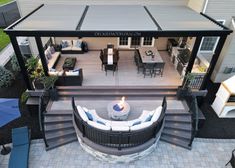 an aerial view of a patio with seating and fire pit