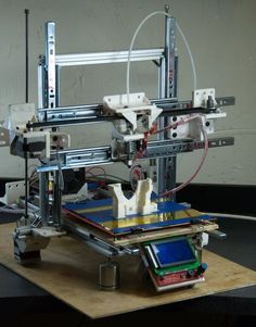 a machine that is sitting on top of a table next to some wires and other items