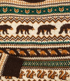 an old sweater with bears on it is shown in close up view, showing the colors and patterns