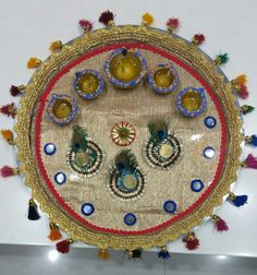 an elaborately decorated table with blue and red decorations on it's surface, surrounded by tassels