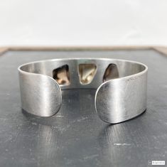 "This beautiful Modernist Scandinavian bracelet was made by Finnish studio Kasityo around 1960 and features three high relief polished quartz cabochons bezel set in 916 silver (Finnish standard). It's a really elegant piece and would look great in a stack! Measures 3/4\" width. Interior measurements 2 3/8 x 2\". Opening 5/8\" wide but this cuff is flexible and will stretch up to 1\". Stamped \"KASITYO\" with full Finnish hallmarks for 916 silver and 1962 date mark. Weighs 36.8 grams. In overall Modern Polished Cuff Bracelet For Anniversary, Contemporary Formal Bracelet With Oyster Design, Modern Handmade Cuff Bracelet For Formal Events, Modern Handmade Cuff Bracelet For Formal Occasions, Modern Cuff Bracelet With Oyster Design For Gift, Handmade Modernist Bracelets For Formal Occasions, Unique Sterling Silver Cuff Bracelet With Polished Finish, Modern Handmade Cuff Bracelet For Formal Wear, Contemporary Sterling Silver Bracelet Gift