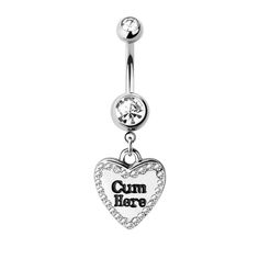 a heart shaped belly ring with the words cum here on it and a crystal stone in the center