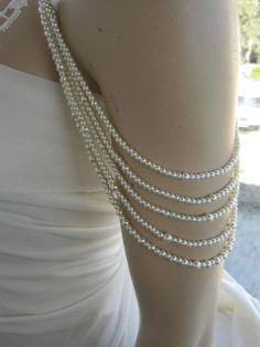 Shoulder Necklace Bridal shoulder necklace 2 pieces per order. 4 handcrafted pearl and brooch Shoulder Necklace Bridal shoulder necklace 2 pieces per order handcrafted beaded made to order Please get in touch for more information. Thank you so much for choosing my store. It is very importent to let my customers happy, so dont hesitate to contact me for your questions. Standart shipping I ship from Turkey , General delivery durations are USA : 12 /20 days Canada : 10/20days Australia: 15/25 days Off The Shoulder Dress Jewelry Necklaces, Elegant White Body Jewelry For Evening, Elegant Beaded Pearl Body Jewelry, Elegant White Pearl Chain Body Jewelry, Elegant White Body Jewelry With Pearl Chain, Elegant Beaded Body Jewelry For Wedding, Elegant Body Jewelry For Formal Occasions, Elegant Formal Body Jewelry, Delicate Beaded Pearl Necklace For Wedding