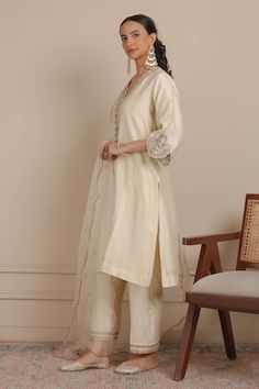 Ivory kurta with floral embroidered scallop hem sleeve and neckline. Paired with an embroidered hem pant and scallop border dupatta. - Aza Fashions Off White Embroidered Palazzo Set For Wedding, Wedding Off White Palazzo Set With Embroidered Border, Wedding Off-white Embroidered Palazzo Set, Wedding Cream Palazzo Set With Embroidered Border, White V-neck Sets With Floral Embroidery, Cream Sets With Embroidered Border, Fitted Cream Sets With Embroidered Border, Cream Fitted Sets With Embroidered Border, Scallop Border