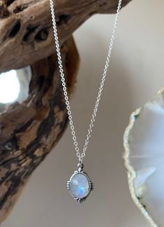 Classic handmade silver necklace with a large high quality beautiful rainbow moonstone that is known to be a stone of love that provides calmness & protection.  This is a simple but stunning necklace that has beautiful curved detailing around the edge.  I handpick all the moonstone stones and no two are identical as they are all natural stones. The moonstones vary in colour and some are more milky than others and some are more transparent with flashes of blue/ the spectrum. If you have a specific requirement please message me as I can see what stones I have in stock and can handpick one just for you.  This necklace is a classic vintage everyday piece that is very wearable and it makes a beautiful simple statement as well as being a pretty piece of jewellery to dress an outfit up. The neckl Mystical White Moonstone Necklaces, Mystical White Moonstone Necklace, Silver Moonstone Moon Necklaces, Bohemian Moonstone Birthstone Necklace, Spiritual Moonstone Birthstone Necklace, White Moonstone Crystal Necklace With Moon Charm, White Moonstone Moon Phase Necklace, White Mystical Gemstone Necklace, Dainty Moonstone Necklace With Natural Stones