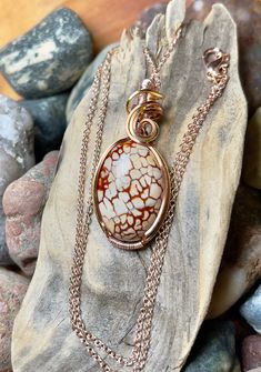 "Dragon vein agate pendant with antique copper, silver, and rose gold wire wrap Comes with 18\" chain shown in photos. Pendant measures 1-5/8\" x 3/4\"" Wire Wrapped Ocean Jasper Pendant Jewelry, Oval Jasper Cabochon Jewelry, Oval Cabochon Jasper Jewelry, Wire Wrapped Round Agate Jewelry, Handmade Silver-plated Wire Necklaces, Silver Gemstone Necklace With Copper Wire, Handmade Silver Plated Wire Necklaces, Wire Wrapped Silver Plated Pendant Necklace, Handmade Jasper Round Pendant Jewelry