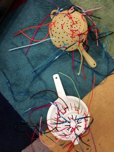 two white bowls with sprinkles on them sitting next to each other in front of a blue towel