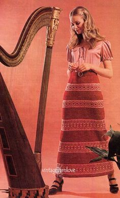 a woman standing next to a harp and bird