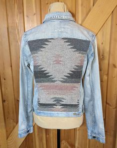 This is a unique made in Montana western wool and denim jacket! Hand sewn by me using an upcycled denim jacket and a wool blend blanket panel sewn onto the back. Just like the more expensive Pendleton coats, but machine washable on gentle cycle and can be dried on low heat. Due to the drape of the coat the back panel may appear crooked, rest assured it was carefully measured before sewing and this is just an illusion. Measurements/Details:  (PLEASE REFER TO PICTURE IN LISTING) *Sleeve Length: 24 1/2 inches *Length of Back: 19 1/2 inches *Width Across Back: 14 1/2 inches *Length from Armpit to Hem: 12 inches *Width at Hip: 18 inches *Width Across Back at Armpit: 19 inches *Materials: Cotton denim, Wool Blend Blanket Fabric, poly blend thread *Brand/Size: Kut from the Cloth, Size XL Hint: To Montana Western, Jacket Patchwork, Upcycled Denim Jacket, Patchwork Coat, Cowgirl Rodeo, Custom Denim, Pendleton Wool, Upcycled Denim, Wool Jacket