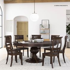 a dining room table with chairs and a white rug