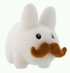 a white stuffed animal with a brown nose and moustache on it's face