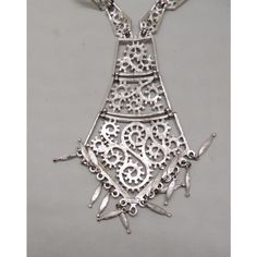 This is part of Chairish’s Costume Jewelry assortment.  Rhodium plated textured openwork 3 part articulated tie like pendant with fringe drops and articulated link chain with hook clasp and extension chain. Marked "Monet" on the hang tag and "Monet©" on the back of the pendant. Pendant measures: 5 inches long by 2 7/8 inches. Chain doubled measures 12 3/4 inches. Excellent condition. From Monet's 1973 Paisley line. A variation on this necklace was featured in a 1973 advertisement. Elegant Lariat Necklace For Festivals, Elegant Silver Chain Necklace For Festival, Elegant Metal Chain Necklace, Elegant Silver Chain Jewelry For Festivals, Elegant Metal Chain Necklace With Dangle, Elegant Metal Dangle Chain Necklace, Silver Long Drop Jewelry For Festivals, Elegant Dangle Lariat Necklace For Festivals, Elegant Metal Lariat Necklace For Formal Occasions