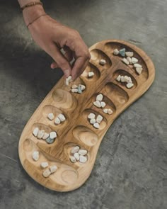 Mancala games are a family of turn-based strategy board games for two players played with small stones, beans or seeds and a series of holes or openings in the ground, board or other playing surface. The goal is usually to capture all or some set of the opponent's pieces. Each game is unique, so we give you the opportunity to see all the options available. You can choose the exact commission before or after your purchase. HOW TO PLAY https://www.youtube.com/watch?v=OX7rj93m6o8 We use FedEx for delivery. So you can receive your game in 3-7 business days. Mancala Board, Homemade Xmas Gifts, Pottery Games, Mancala Game, Board Games For Two, Homemade Board Games, Easy Homemade Gifts, Strategy Board Games, Wood Games