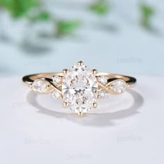 an oval cut diamond ring with three pear shaped diamonds