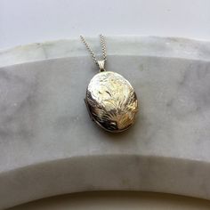 This beautiful vintage locket has an engraved scroll pattern on the front and a plain back. It comes on a modern sterling silver 18" chain or with no chain, please select which from the dropdown box.Hallmarked with the makers mark 'ZJ' and Sterling Silver 925 on the bail.Locket measurements: 3.2cm height, 2.5cm width, 0.7cm depth.The necklace will come beautifully presented in a Lime Tree Design box.IMPORTANT INFORMATION REGARDING SHIPPING:Orders to UK addresses are sent using Royal Mail  which Vintage Sterling Silver Engraved Locket Necklace, Vintage Engraved Sterling Silver Locket Necklace, Ornate Engraved Round Locket Necklace, Ornate Engraved Round Pendant Locket Necklace, Antique Sterling Silver Etched Locket Necklace, Antique Silver Engraved Locket Necklace For Anniversary, Antique Engraved White Gold Locket Necklace, Antique Etched Sterling Silver Locket Necklace, Vintage Engraved White Gold Locket Necklace