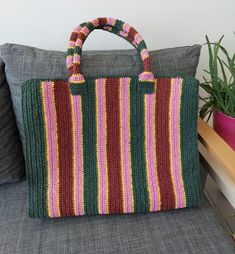 An ideal "Weekender Bag" that is lightweight, colorful, and striped. This striped straw bag is perfect for beach outings or daily use, adding a touch of natural elegance to any outfit. Crafted from high-quality materials, this handmade shoulder bag exudes a trendy and eco-friendly vibe. This versatile purse offers ample space for your essentials while complementing your summer wardrobe effortlessly. Whether you're strolling along the shore or exploring the city streets, this stylish straw bag will be your go-to companion. Our chic handbag is a must-have accessory for the fashion-forward individual. Make a sustainable fashion statement with our natural wicker shoulder bag, which combines functionality with timeless appeal.  100% Handmade Dimensions: *48 cm *36 cm*15 cm Green Crochet Beach Bag For Vacation, Green Jute Tote Beach Bag, Pink Square Crochet Bag For The Beach, Pink Bohemian Crochet Bag For Shopping, Green Crochet Beach Bag, Bohemian Pink Crochet Bag, Pink Bohemian Rectangular Straw Bag, Green Woven Crochet Bag For Beach Season, Green Crochet Tote Straw Bag