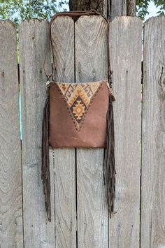 Crossbody or shoulder big fringe bag. Orange, brown & taupe rug compliments this bohemian design. The backside is brown canvas with a deep 9" zip pocket. It has a leather adjustable strap. Top zip to keep your goods safe. Fully lined with an inside zip pocket. Measures 11" x 11".  The fringe measures 12" long and sits 11-12" below the bottom of the bag. Fringe is unique :, some are short, some long. Free Domestic shipping!. Brown Hobo Bag With Tassels For Travel, Travel Hobo Bag With Fringe In Brown, Brown Tasseled Hobo Bag, Brown Satchel With Tassels For Everyday Use, Bohemian Brown Satchel With Removable Pouch, Brown Tassel Satchel For Everyday Use, Brown Tassel Hobo Tote Bag, Brown Fringe Shoulder Bag For Everyday Use, Brown Fringe Bag For Everyday Use