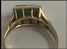 The jade is carved with a flower and is a bright emerald green with a stem and scroll., beautifully displayed in a raised gold cage, and bezel set in 14k yellow gold women's jewelry. Although antique, this jade ring has a contemporary look that complements today's tastes. Specifications: Metal: 14K Yellow Gold Style: Statement Ring Ring Size: 4 Gemstone Specifications: Center Gemstone: Jade Shape: RectangularColor: GreenCut: Cabochon Boxed - Only One Available Free shipping via USPS in 2 - 7 Day Antique Green Emerald Cut Ring, Antique Green Emerald-cut Emerald Ring, Antique Green Emerald Cut Emerald Ring, Art Deco Green Emerald Ring In 14k Gold, Antique Emerald Cut Green Emerald Ring, Victorian Green Jewelry Stamped 14k, Art Deco Emerald Ring In 14k Gold, Antique Emerald Ring In Stamped 14k Yellow Gold, Antique Green Ring With 17 Jewels