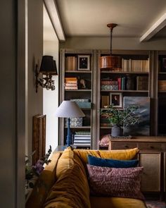 a living room filled with furniture and bookshelves