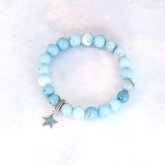 Experience the calming energy of the ocean with our Ocean Starfish Larimar Beaded Bracelet. This beautiful bracelet features a Larimar beaded strand, known for its soothing and healing properties, and is adorned with a charming starfish pendant charm made of solid 925 sterling silver. Add a touch of elegance and serenity to your wardrobe. Materials: Larimar, 925 sterling silver You can choose the option with the starfish charm or without the starfish charm. Jewelry Care: See more information about how to care for your jewelry here. Shipping Policy: Orders will be shipped within 1-3 business days. Economy shipping will take 7-14 days to arrive and standard shipping is 1- 4 days for U.S. orders. International shipping time is depended on the country and per shipping method. Shipping cost wil Ocean Starfish, Starfish Pendant, Silver Jewelry Earrings, Handmade Fashion Jewelry, Screw Back Earrings, Healing Properties, Jewelry Earrings Studs, Silver Charms, Solid 925 Sterling Silver