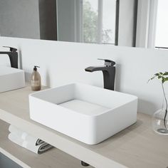 a white sink sitting on top of a wooden counter